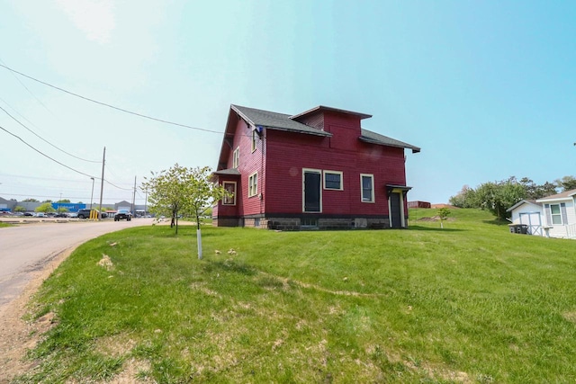 view of property exterior featuring a lawn