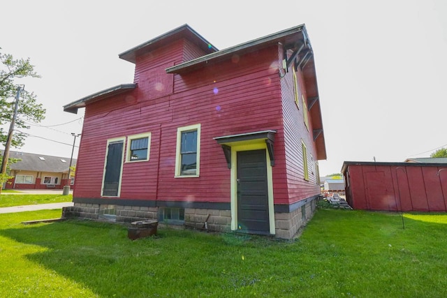 rear view of house featuring a yard