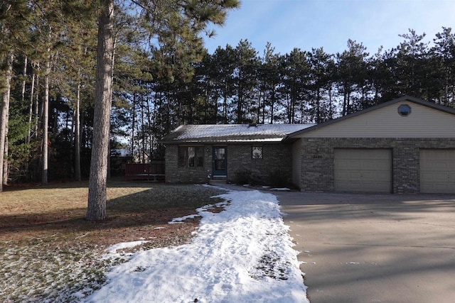 ranch-style home featuring a garage and a wooden deck