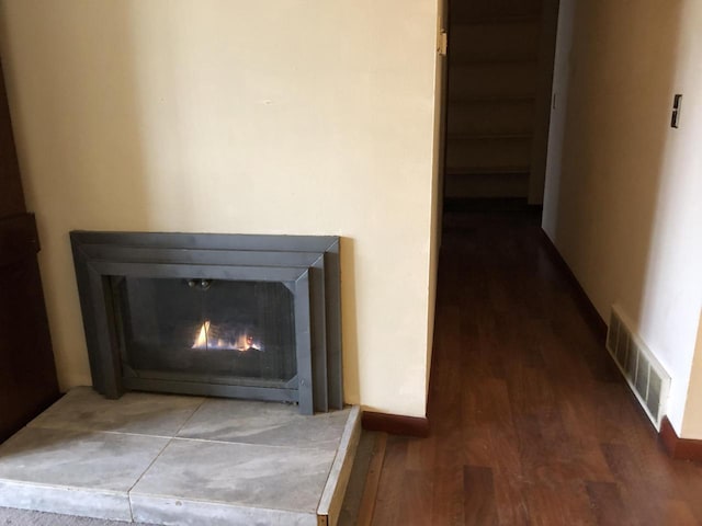 interior details with hardwood / wood-style flooring and a fireplace