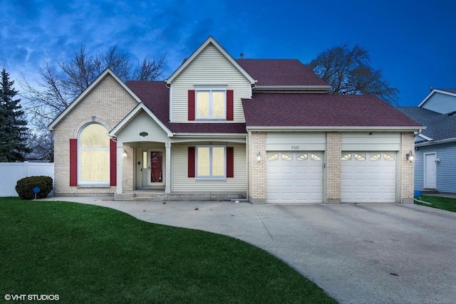 front facade featuring a front lawn and a garage