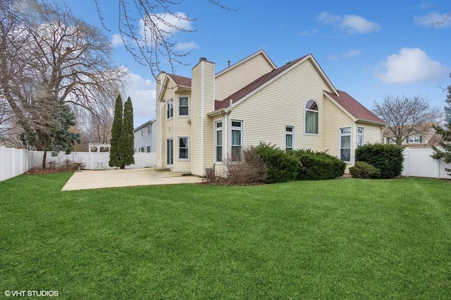 back of property with a yard and a patio