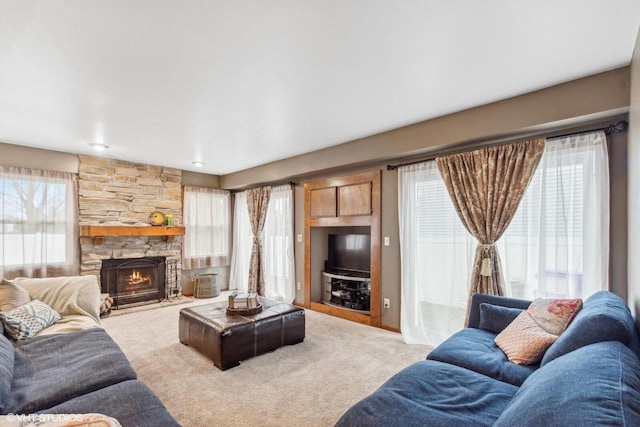 living room with a fireplace and carpet floors