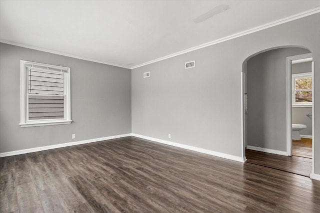 spare room with dark hardwood / wood-style flooring and ornamental molding