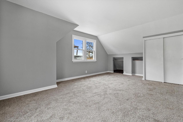 additional living space featuring carpet and lofted ceiling