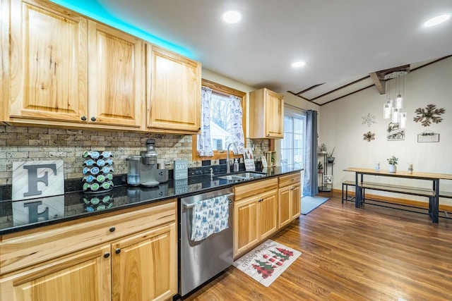 kitchen with light brown cabinets, sink, hanging light fixtures, stainless steel dishwasher, and dark hardwood / wood-style floors