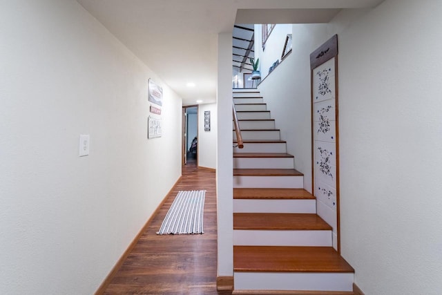 stairs featuring hardwood / wood-style flooring