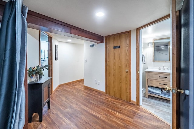 hall with sink and dark wood-type flooring