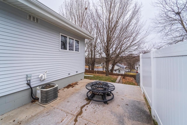 view of patio with a fire pit and central AC unit