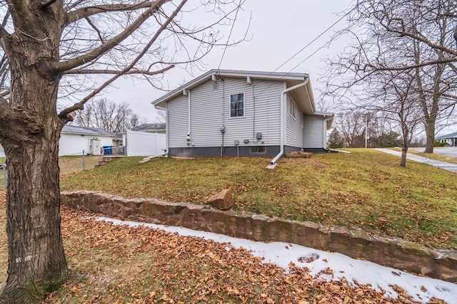 view of side of home featuring a lawn