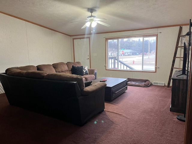 living room with a textured ceiling, dark carpet, ceiling fan, and ornamental molding