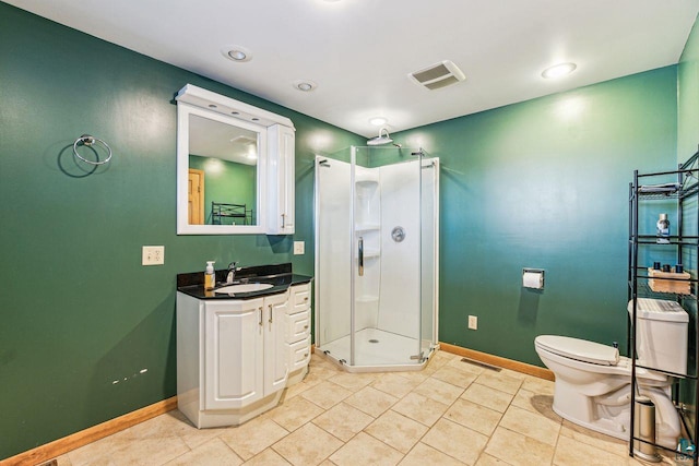 bathroom featuring tile patterned flooring, toilet, vanity, and walk in shower