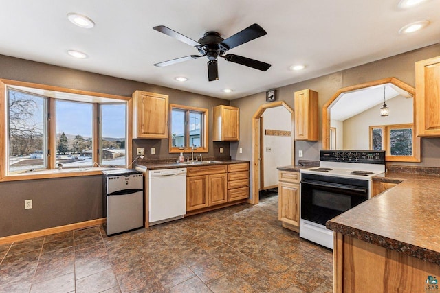 kitchen featuring white appliances, lofted ceiling, sink, ceiling fan, and decorative light fixtures