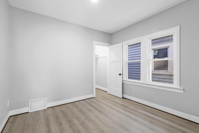 unfurnished room with light wood-type flooring