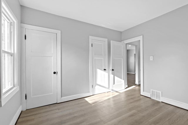 unfurnished bedroom featuring light wood-type flooring