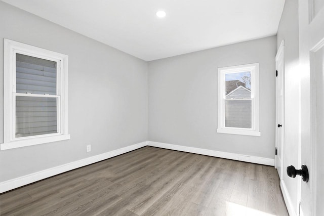 empty room with hardwood / wood-style flooring