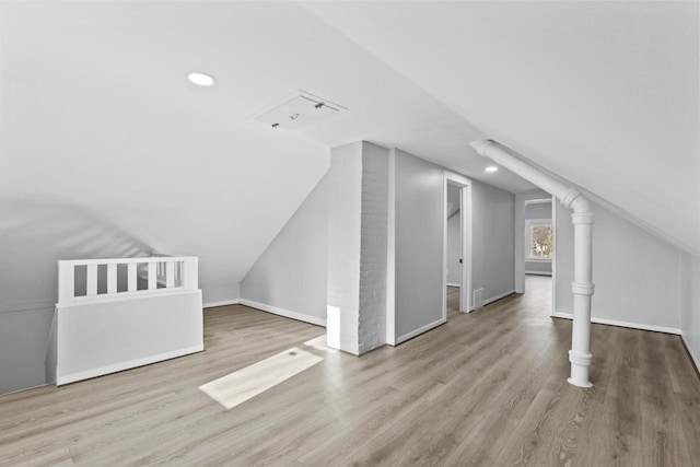 bonus room with light hardwood / wood-style floors and vaulted ceiling