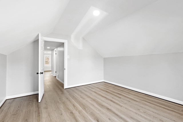 bonus room with light hardwood / wood-style floors and lofted ceiling