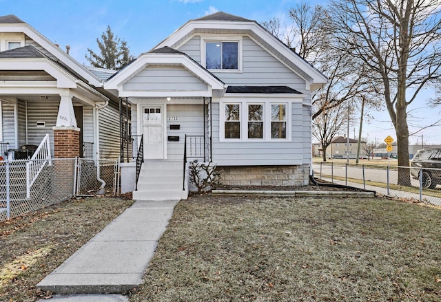 bungalow-style home featuring a front lawn