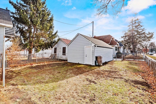 view of side of home with an outbuilding and a yard