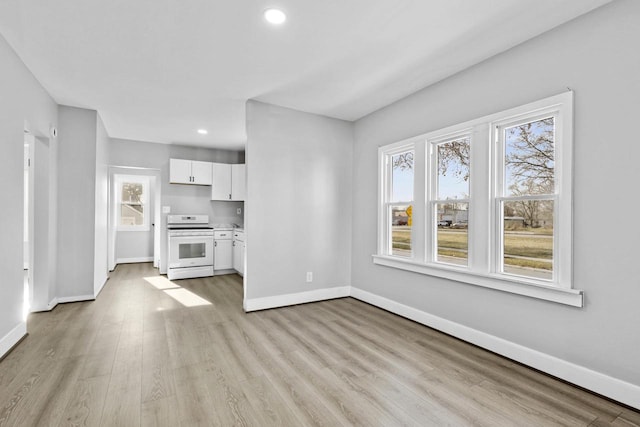 unfurnished living room featuring light hardwood / wood-style flooring and a wealth of natural light