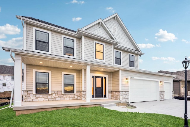 view of front of home featuring a porch and a garage