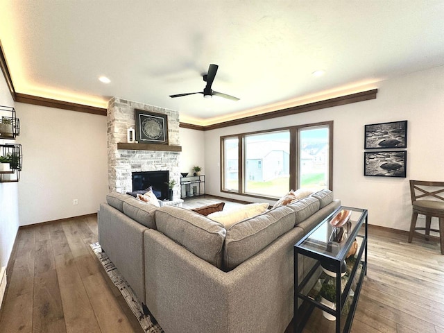 1217 Bay Mist Dr, Green Bay, WI 54311 - living room featuring a fireplace, hardwood / wood-style flooring, ceiling fan, and crown molding