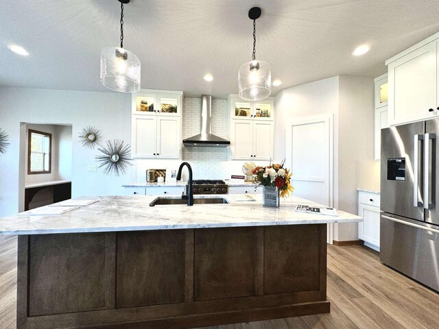 1217 Bay Mist Dr, Green Bay, WI 54311 - kitchen with stainless steel fridge, pendant lighting, a large island with sink, and wall chimney exhaust hood