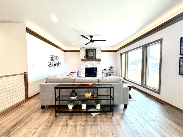 1217 Bay Mist Dr, Green Bay, WI 54311 - living room featuring a fireplace, light hardwood / wood-style flooring, ceiling fan, and ornamental molding
