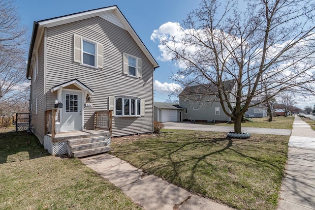 view of front of house featuring a garage, an outdoor structure, and a front lawn