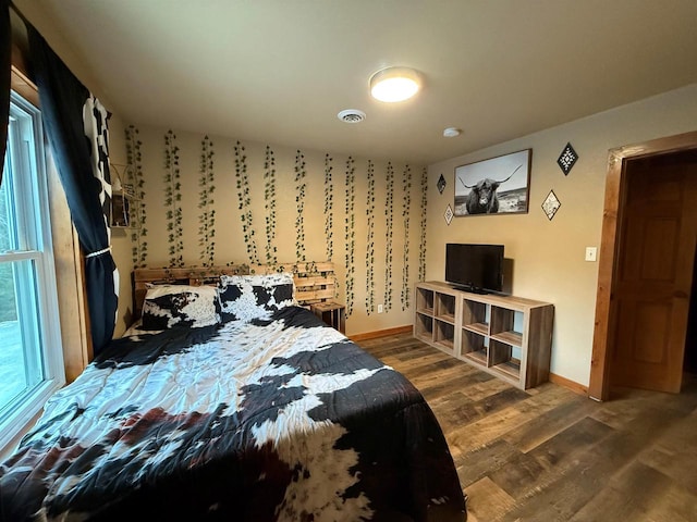 bedroom with dark wood-type flooring