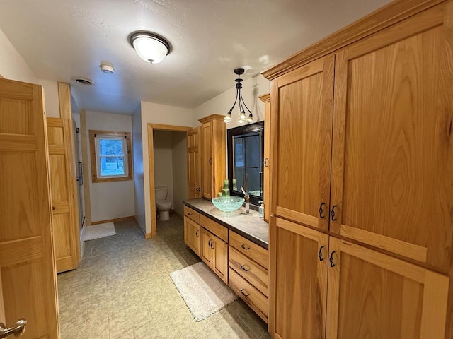 bathroom featuring vanity and toilet