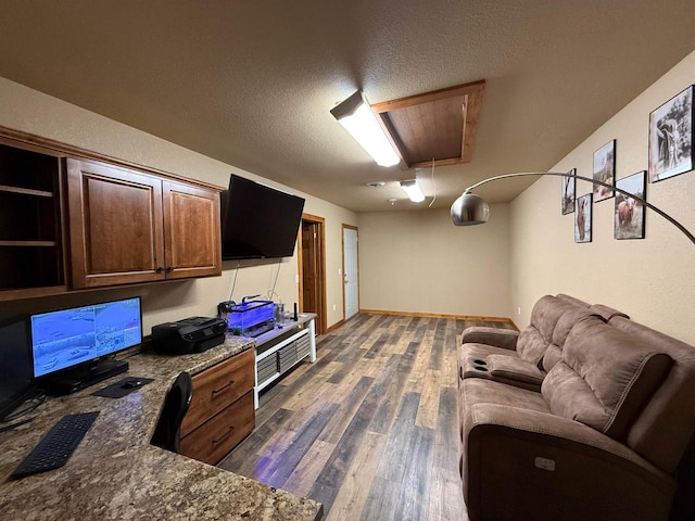 living room featuring a textured ceiling and dark wood-type flooring