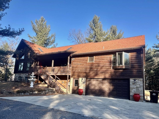 cabin with a garage and a deck