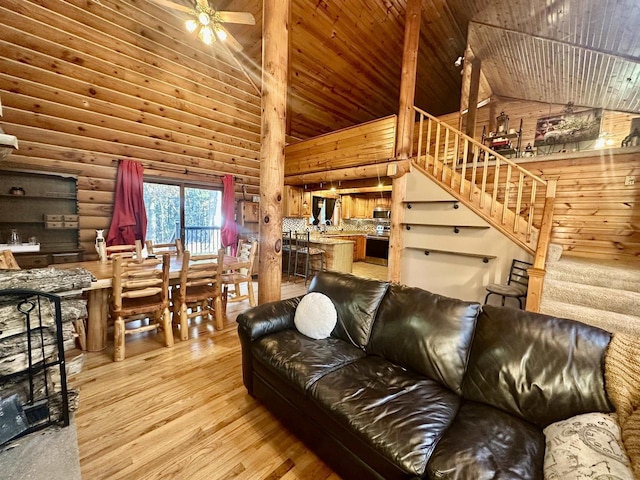 living room featuring ceiling fan, high vaulted ceiling, wooden ceiling, and hardwood / wood-style flooring