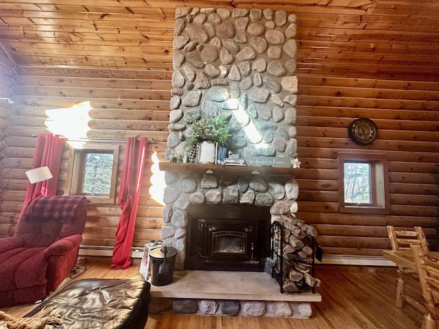 interior space with a wood stove, a wealth of natural light, hardwood / wood-style floors, and log walls