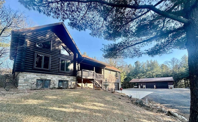 view of home's exterior featuring a garage, an outdoor structure, and a yard