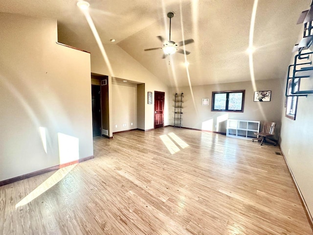 unfurnished living room featuring hardwood / wood-style flooring, ceiling fan, and lofted ceiling