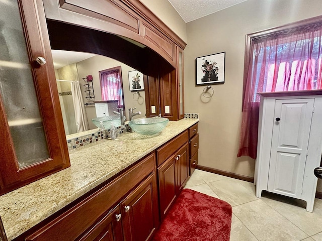 bathroom with a shower with curtain, tile patterned flooring, vanity, and a textured ceiling