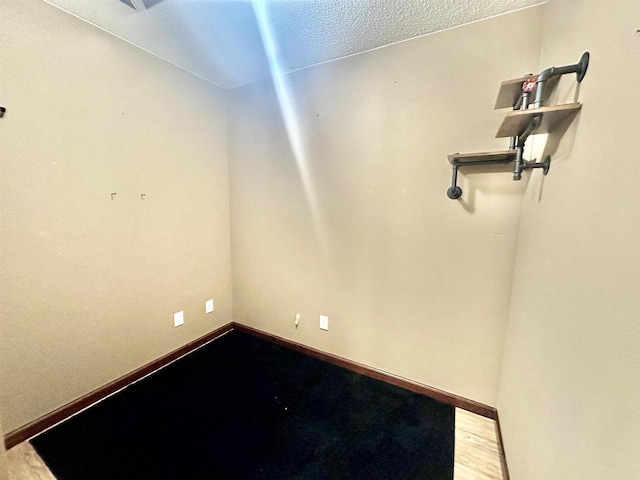 empty room featuring hardwood / wood-style floors and a textured ceiling