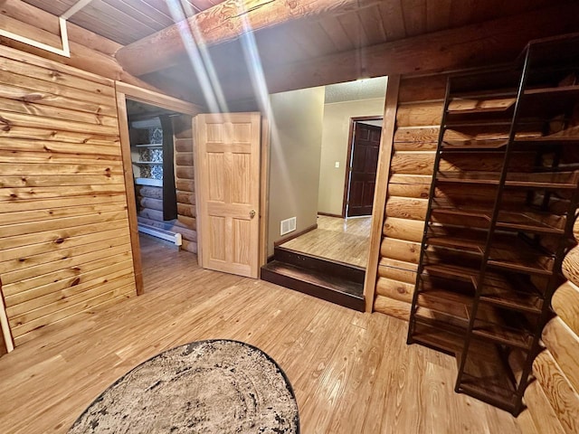 corridor with rustic walls, hardwood / wood-style floors, and wooden ceiling