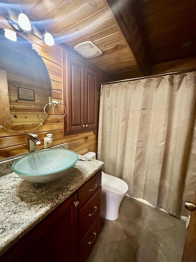 bathroom featuring wooden walls, vanity, wood ceiling, and toilet