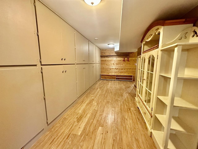 interior space featuring wooden walls and light hardwood / wood-style flooring