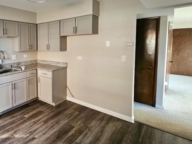 kitchen featuring dark hardwood / wood-style floors, gray cabinets, and sink