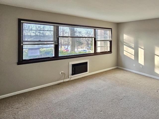 spare room with carpet and a wall mounted air conditioner