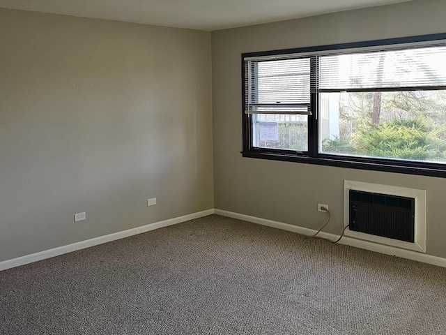 spare room featuring carpet flooring and a wall mounted air conditioner