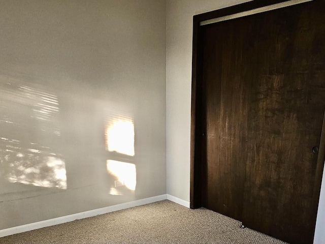 unfurnished room featuring light colored carpet