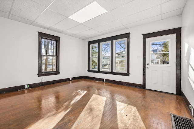 entryway with hardwood / wood-style floors and a paneled ceiling