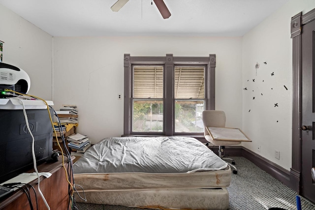 bedroom featuring ceiling fan and dark colored carpet