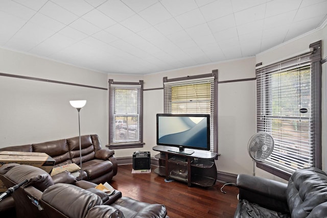 living room with ornamental molding and dark wood-type flooring